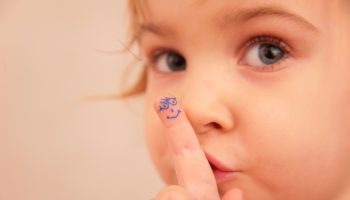 little girl and finger with painted face