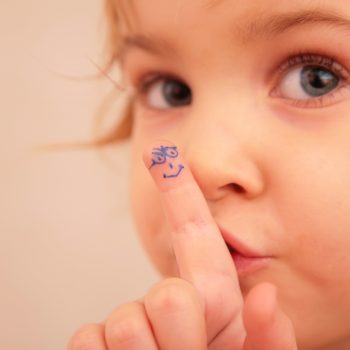 little girl and finger with painted face