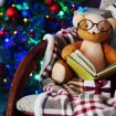 Teddy bear with book and gift boxes in rocking chair